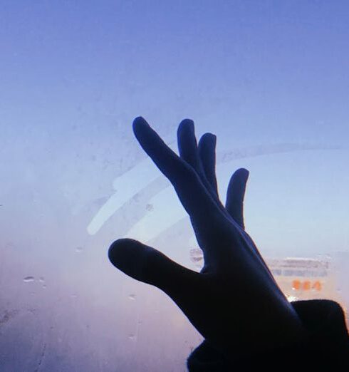 Boundaries - Hand Reaching out towards Sky through Fogged up Train Window