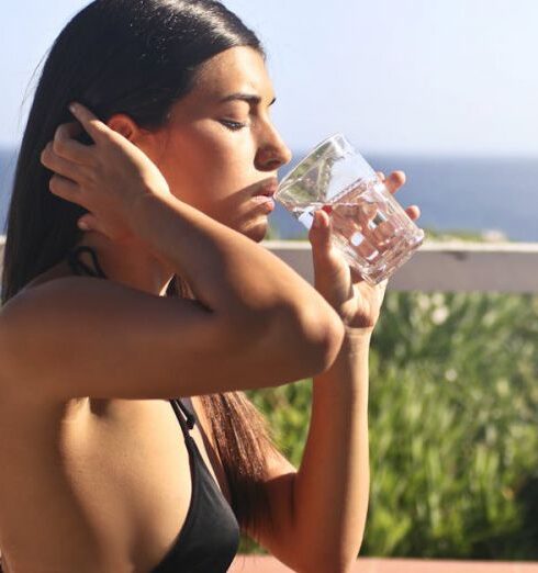 Drink Water - Photography of a Woman Wearing Black Bikini Drinking Water