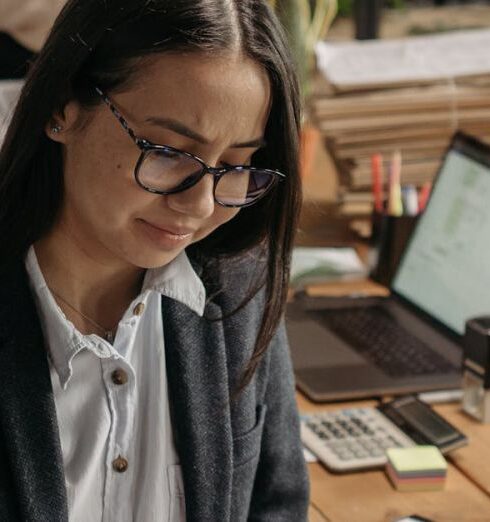 Tasks - Young Women Sitting at the Desk with Laptops in an Office