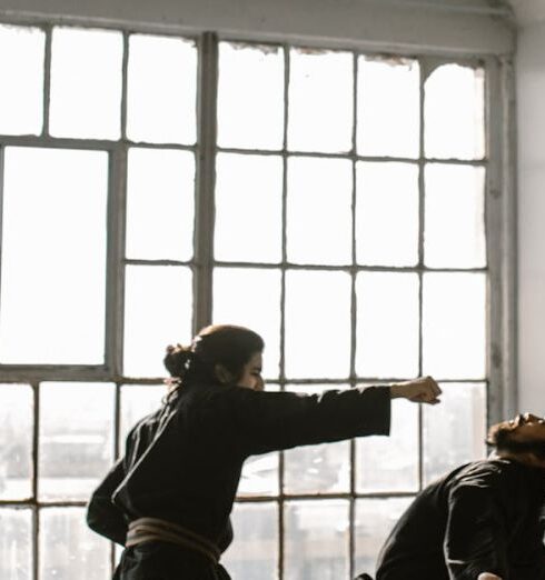 Technique - A Pair of Men in Black Dobok Showing a Self Defense Move