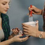 Tasks - A Woman in Plaid Long Sleeves Holding a Paintbrush