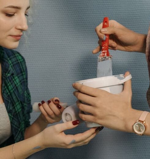 Tasks - A Woman in Plaid Long Sleeves Holding a Paintbrush