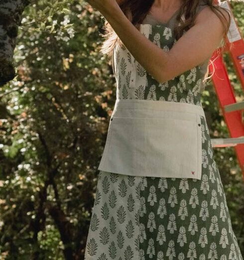 Routine - A Woman Hanging a White Towel on Clothes Line