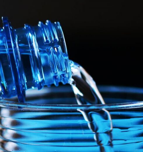 Drink Water - Close-up of Bottle Pouring Water on Glass