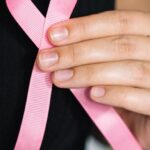 Fundraising - Woman in Black Tank Top Holding Pink Ribbon