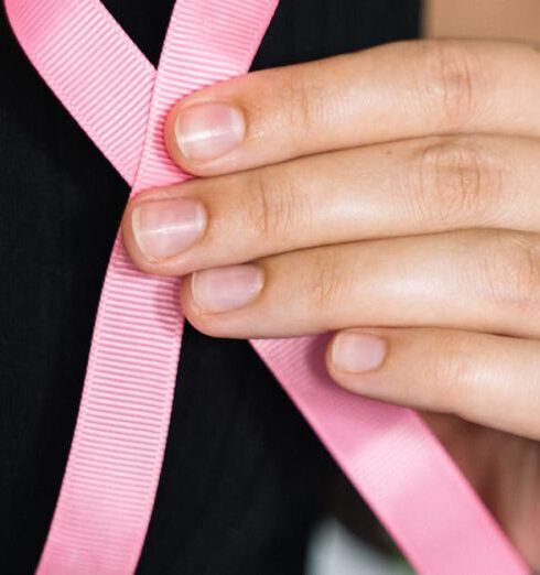 Fundraising - Woman in Black Tank Top Holding Pink Ribbon