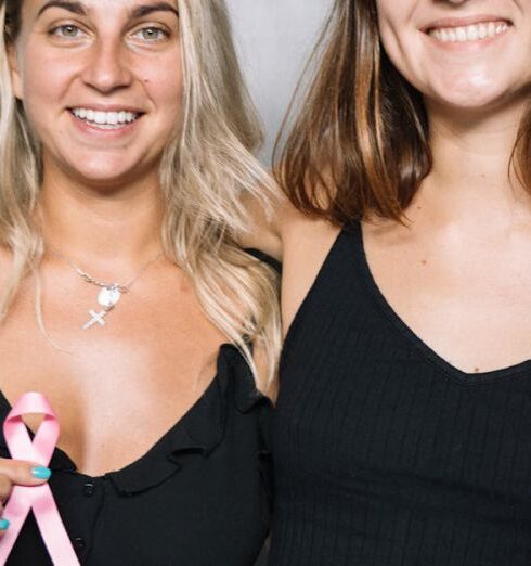 Volunteering - 2 Women in Black Tank Top Holding Pink Ribbon