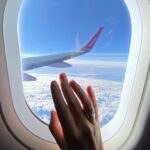 Sector - Girl's hand on the porthole in the plane in flight