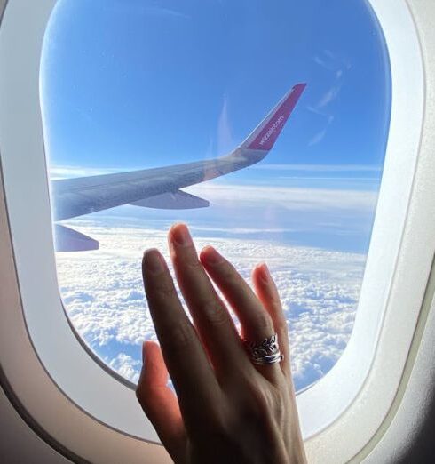 Sector - Girl's hand on the porthole in the plane in flight