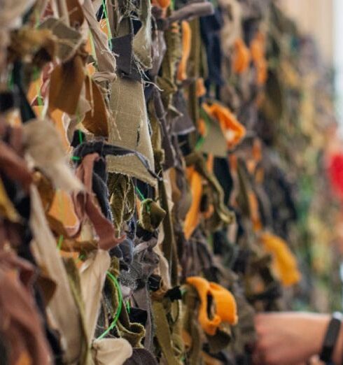 Volunteering - Women Tying Scrap Textile to a et