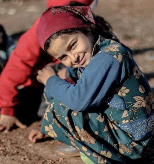 Refugees - Children Playing Outside in the Mud