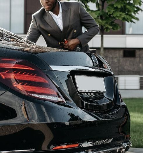 Opportunities - A Man in Black Suit Standing Beside Black Car