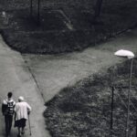 Care - Man Walking Beside Woman on Road