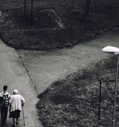 Care - Man Walking Beside Woman on Road