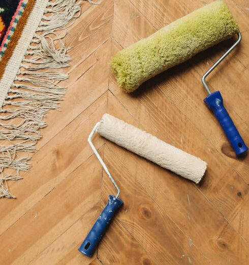 Tools - Paint Rollers Lying on a Wooden Floor 