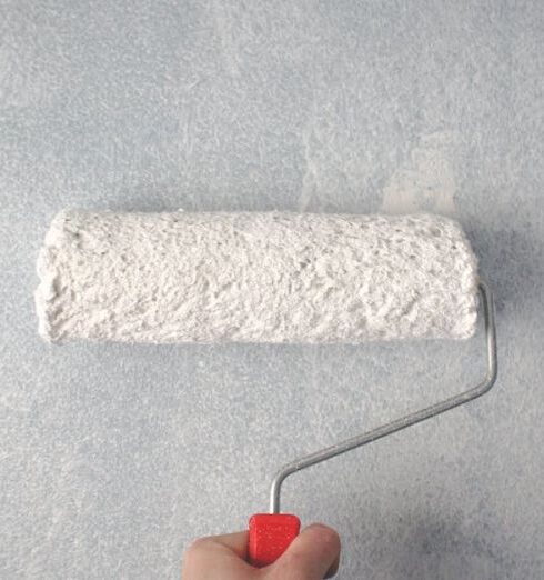 Painting - Person Holding Paint Roller On Wall