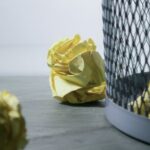 Bin - Focus Photo of Yellow Paper Near Trash Can