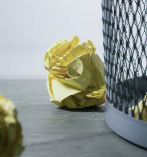 Bin - Focus Photo of Yellow Paper Near Trash Can