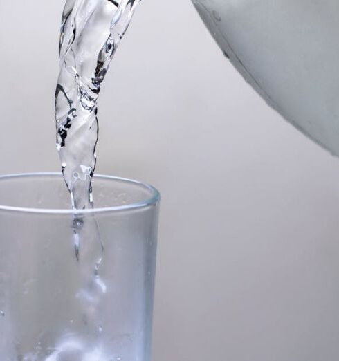 Drink Water - Clear Glass Pitcher Pouring Water on Clear Drinking Glass