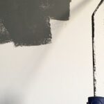 Painting - Person Holding Paint Roller While Painting the Wall