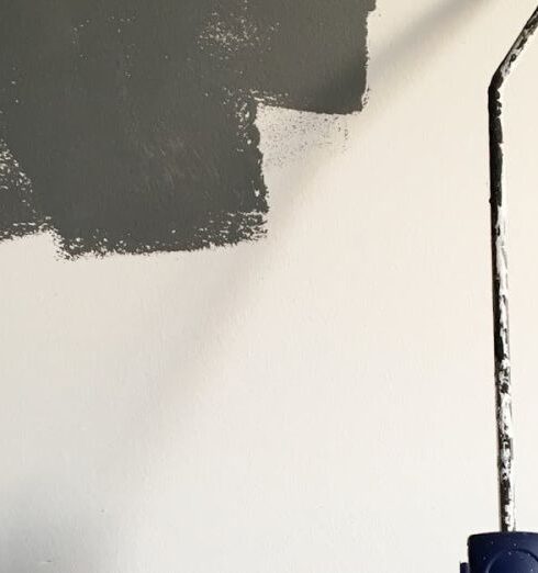 Painting - Person Holding Paint Roller While Painting the Wall