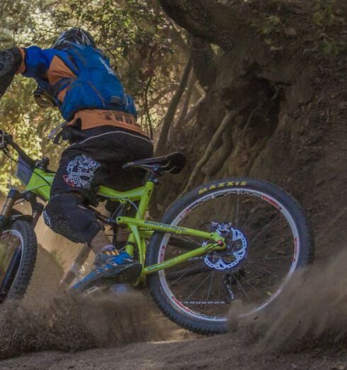 Mountain Biking - Man in Black and Orange Bicycle Riding Jacket With Green Off Road Bike