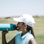 Drink Water - Woman Drinking at Blue Sports Bottle Outdoors