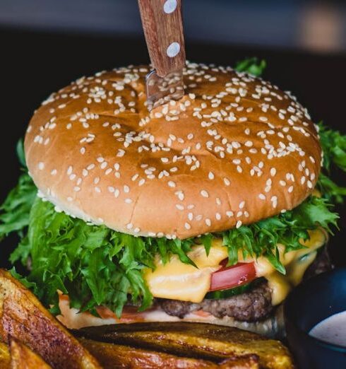 Cuisine - Burger With Fried Fries on Black Plate With Sauce on the side