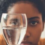 Drink Water - Woman Staring on Glass Bottle