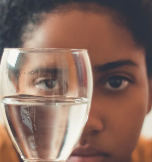 Drink Water - Woman Staring on Glass Bottle