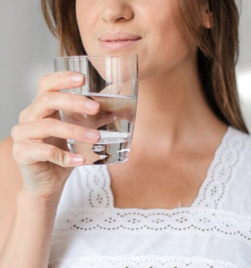 Drink Water - Woman in White Floral Lace Sleeveless Dress Holding Clear Drinking Glass