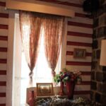 Homestay - Two Brown Window Curtains Inside White and Red Room