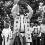 Religious Festivals - A Group of People Looking at a Man Holding a Smoking Pot at a Ceremony