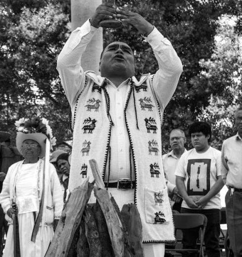 Religious Festivals - A Group of People Looking at a Man Holding a Smoking Pot at a Ceremony