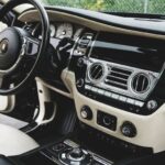 VIP Experience - Expensive luxury car interior with white leather seats and shiny dashboard