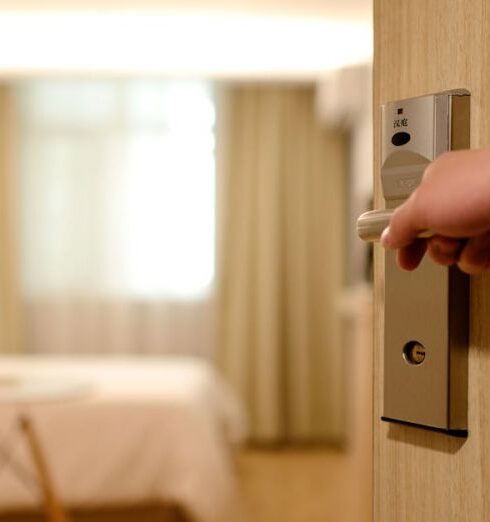 Hotels - Person Holding on Door Lever Inside Room