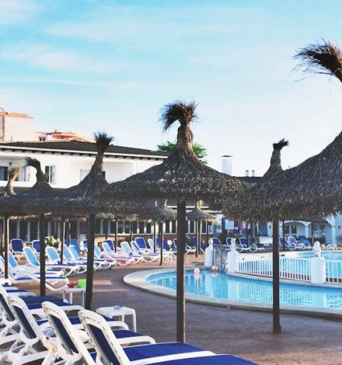 Beach Resorts - White Plastic Beach Loungers Near Pool at Daytime