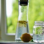 Drink Water - Shallow Focus Photography of Yellow Lemon Near Glass Mason Jar and Glass Decanter