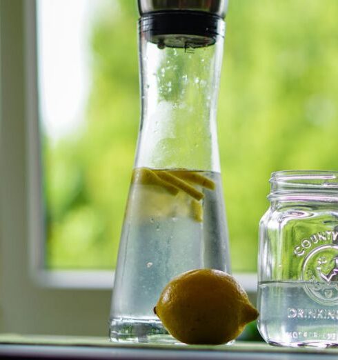 Drink Water - Shallow Focus Photography of Yellow Lemon Near Glass Mason Jar and Glass Decanter