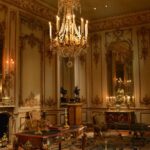 Palace - Brown Wooden Coffee Table Below an Uplight Chandelier