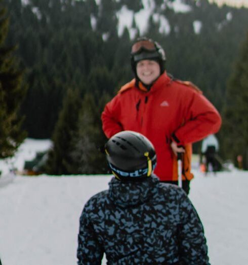 Ski Trip - Group of men with snowboard and ski on snowy terrain near trees under cloudy sky on weekend