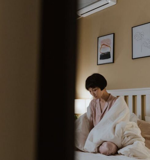 Loneliness - Woman Sitting on White Bed