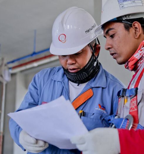 Safety - Two Man Holding White Paper