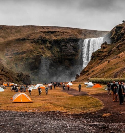 Travel Groups - People Standing on Camping Site Near Waterfalls