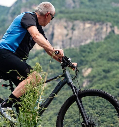 Hiking Trails - Senior Biker Riding Mountain Trails Outdoors