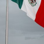 Foreign Country - monumental mexican flag waving on a rainy day in puebla