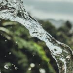 Drink Water - A Man Pouring A Glass of Water Under Cloudy Sky