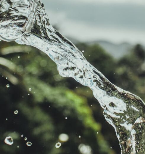 Drink Water - A Man Pouring A Glass of Water Under Cloudy Sky