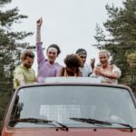 Travel Buddies - Friends Having Fun while Riding at the Back of a Pickup Truck