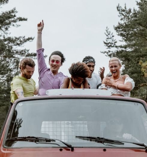 Travel Buddies - Friends Having Fun while Riding at the Back of a Pickup Truck